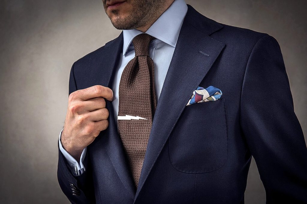 Man in suit, tie with clip